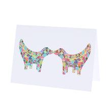 Load image into Gallery viewer, Greeting card showing two Super Lambanana statues kissing each other, in Tula Moon's distinctive colourful patchwork style.