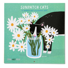 Load image into Gallery viewer, A square wall calendar titled 'SUNPATCH CATS 12 MONTH ART CALENDAR 2027' by The Art File, featuring a black cat drinking from a glass jar of daisies on a mint green background.