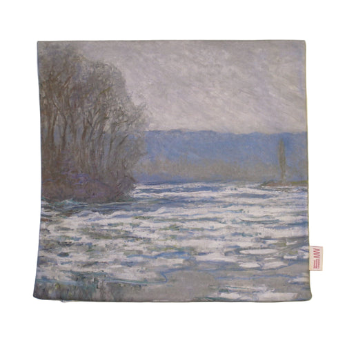 A cushion cover with a landscape print featuring water and trees on a beige background