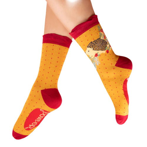Yellow socks with red accents and a hedgehog design on a white background