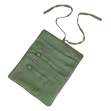 Load image into Gallery viewer, An olive green fabric pouch with three zipper compartments and two long ties, laid flat on a pale pink background.