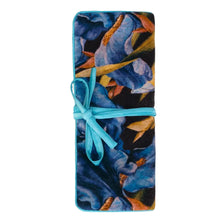 Load image into Gallery viewer, A long, narrow fabric pouch or wrap with a blue floral print and a turquoise ribbon tied in a bow around the middle, shown on a plain light background.