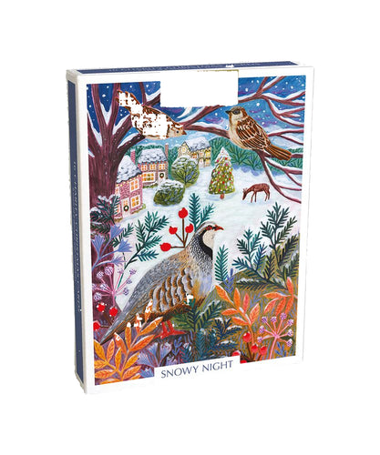 A box of Christmas cards with a partridge in a tree looking over a snowy village.