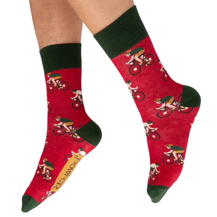 Red socks with bicycle-themed design worn by a person on a white background