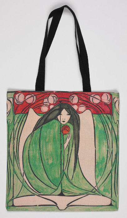 Long handled tote bag showing an illustration of a woman in a green dress, crouched, clutching a red flower with black handles.