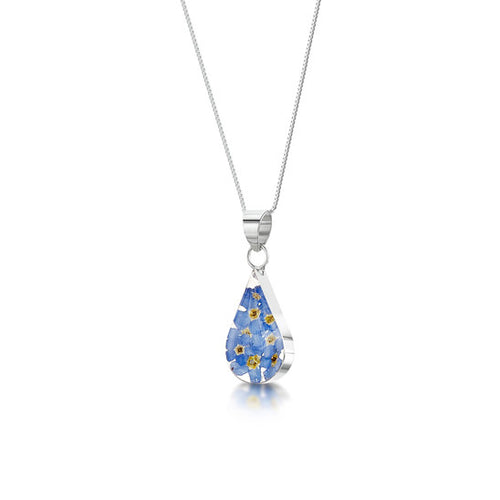 Necklace with a teardrop shaped pendant of resin encasing forget me not flowers on a silver chain.