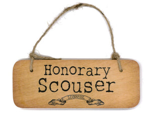 Hanging wooden sign with the phrase honorary scouser on it.
