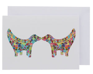 Greeting card showing two Super Lambanana statues kissing each other, in Tula Moon's distinctive colourful patchwork style.