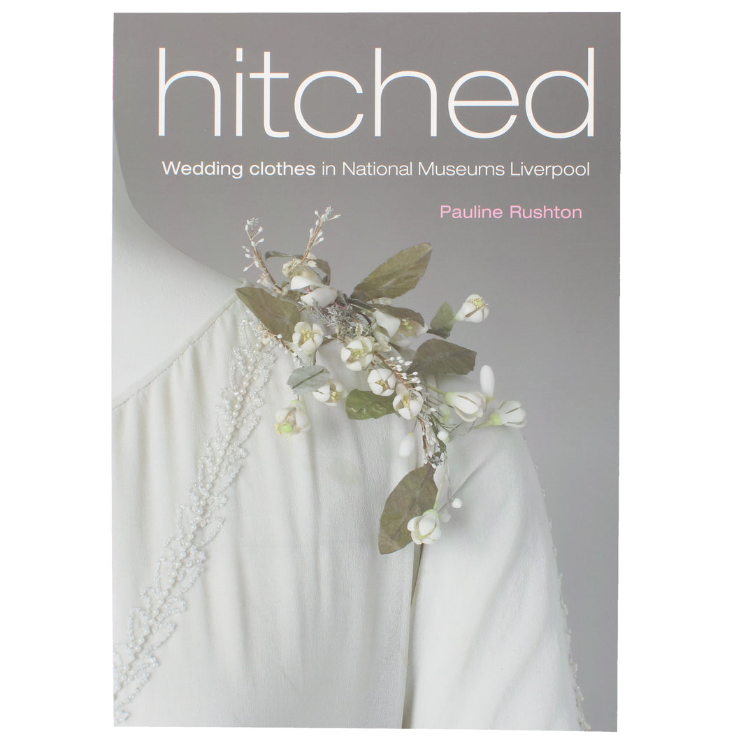 Front cover of Hitched, showing a colour photograph of the shoulder detail of a white dress, with a floral crystal adornment 