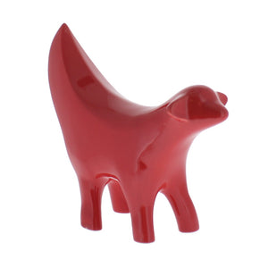 Ceramic red statue, shaped as the front half of a lamb combined with a banana.