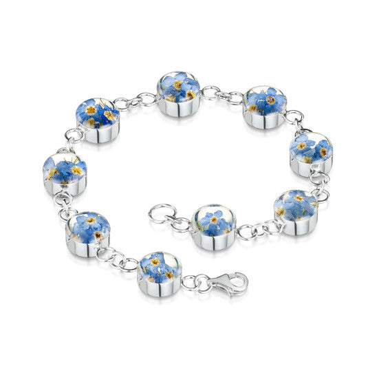 Bracelet made up of circles of resin with forget me not flowers joined by silver chain.