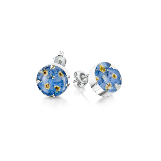 Pair of stud earrings with a circle of resin encasing forget me not flowers on silver backs