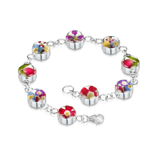 Bracelet composed of a silver chain with interspersed clear resin with flowers set in it.