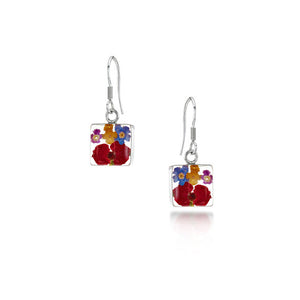 Pair of silver dangling earrings with flowers encased in square resin.